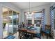 Cozy dining room featuring a chandelier, wood table, and sliding glass doors to the backyard pool at 16226 S 35Th Dr, Phoenix, AZ 85045