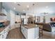 Modern kitchen with a large island, white cabinets, stainless steel appliances, and hardwood floors at 16226 S 35Th Dr, Phoenix, AZ 85045