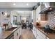 Modern kitchen with white cabinetry, stainless steel appliances, and an open dining area at 16226 S 35Th Dr, Phoenix, AZ 85045