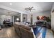 Spacious living room with a ceiling fan, adjacent to a game table area and open to the kitchen at 16226 S 35Th Dr, Phoenix, AZ 85045