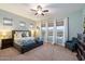 Spacious main bedroom with a ceiling fan, carpet, and large windows providing lots of natural light at 16226 S 35Th Dr, Phoenix, AZ 85045