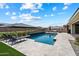 Backyard featuring a sparkling pool, lounge chairs, and manicured desert landscaping at 16226 S 35Th Dr, Phoenix, AZ 85045