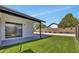 Backyard featuring artificial grass, a concrete patio, and a white fence at 18205 N 18Th St, Phoenix, AZ 85022