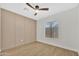 Neutral bedroom featuring an accent wall, wood floor, a ceiling fan and a window with blinds at 18205 N 18Th St, Phoenix, AZ 85022