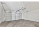 Spacious garage with sealed concrete floor, white door, and automatic door opener at 18205 N 18Th St, Phoenix, AZ 85022