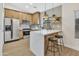 Modern kitchen with stainless steel appliances, quartz countertops, and breakfast bar with seating at 18205 N 18Th St, Phoenix, AZ 85022