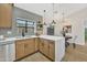 Bright kitchen features light wood cabinets, white countertops, and a dining area with modern light fixture at 18205 N 18Th St, Phoenix, AZ 85022
