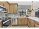 Updated kitchen features modern stainless steel appliances, light wood cabinetry, and ample counter space at 18205 N 18Th St, Phoenix, AZ 85022