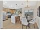 Eat-in kitchen features updated lighting, stainless steel appliances, breakfast bar, and modern cabinetry at 18205 N 18Th St, Phoenix, AZ 85022
