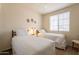 Bright bedroom featuring twin beds, soft lighting, and modern decor for a comfortable stay at 1941 S Pierpont Dr # 2073, Mesa, AZ 85206