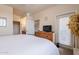 Inviting bedroom featuring a comfortable bed, wooden dresser, and ensuite bathroom access at 1941 S Pierpont Dr # 2073, Mesa, AZ 85206