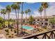 Community pool area lined with palm trees and plenty of lounge chairs for relaxing by the water at 1941 S Pierpont Dr # 2073, Mesa, AZ 85206