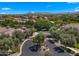 Scenic aerial view of gated community entrance with lush trees and distant mountain views at 19877 S 185Th Way, Queen Creek, AZ 85142