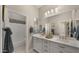 Well-lit bathroom with a double vanity, a large mirror, and modern fixtures at 19877 S 185Th Way, Queen Creek, AZ 85142