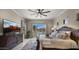 Cozy bedroom with a large bed, ceiling fan, wood floors, and natural light at 19877 S 185Th Way, Queen Creek, AZ 85142