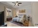 Well-lit bedroom with warm colors, textured wall, bed, TV, and area rug at 19877 S 185Th Way, Queen Creek, AZ 85142