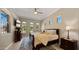 Bright bedroom with a bed, television, ceiling fan, wood floors, and lots of natural light at 19877 S 185Th Way, Queen Creek, AZ 85142