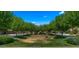 A well-manicured community green space with mature trees and a playground, ideal for families at 19877 S 185Th Way, Queen Creek, AZ 85142