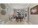 Charming dining room area featuring modern lighting, neutral walls, and seamless transition to the outdoor patio at 19877 S 185Th Way, Queen Creek, AZ 85142