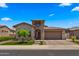 Stunning home featuring a stone turret entry, manicured lawn, and a two-car garage at 19877 S 185Th Way, Queen Creek, AZ 85142