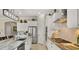 Well-lit kitchen with a large island, stainless steel appliances, white cabinets, and a subway tile backsplash at 19877 S 185Th Way, Queen Creek, AZ 85142
