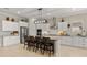 Spacious kitchen features white cabinetry, stainless appliances, an island with seating and hardwood floors throughout at 19877 S 185Th Way, Queen Creek, AZ 85142