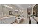 Luxurious main bathroom featuring double vanities, a soaking tub, and a walk-in closet at 19877 S 185Th Way, Queen Creek, AZ 85142