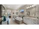 Bright main bathroom with a soaking tub, double vanity sinks, and a view to the bedroom at 19877 S 185Th Way, Queen Creek, AZ 85142