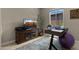 Functional office with a TV and a large window that brings in natural light at 19877 S 185Th Way, Queen Creek, AZ 85142