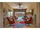A cozy outdoor patio with comfortable seating, a ceiling fan, and a view of the pool at 19877 S 185Th Way, Queen Creek, AZ 85142