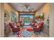 Comfortable patio featuring cushioned chairs, barrel tables, a colorful rug and a ceiling fan for optimal relaxation by the pool at 19877 S 185Th Way, Queen Creek, AZ 85142