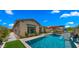 Exterior view showing the pool, patio, and manicured landscaping that enhances the appeal of this charming, single-story home at 19877 S 185Th Way, Queen Creek, AZ 85142