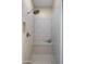 Modern tiled shower with a bench, rainfall shower head, and glass door at 19877 S 185Th Way, Queen Creek, AZ 85142