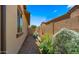 A narrow side yard featuring a gravel path and raised garden beds, perfect for growing vegetables at 19877 S 185Th Way, Queen Creek, AZ 85142