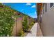 Landscaped side yard with brick pathway and flowering bushes, offering a serene outdoor space at 19877 S 185Th Way, Queen Creek, AZ 85142
