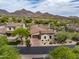 Aerial view of home showcasing tile roof, desert landscaping, mountain views, and community features at 20055 N 96Th Way, Scottsdale, AZ 85255