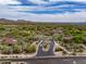 Sweeping aerial view showcases the scenic desert community with homes connected by winding roads, blending nature and luxury at 20055 N 96Th Way, Scottsdale, AZ 85255