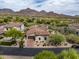 Aerial view of home showcasing tile roof, desert landscaping, mountain views, and community features at 20055 N 96Th Way, Scottsdale, AZ 85255