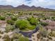Dramatic aerial showcasing a vibrant community nestled within the desert landscape, set against a backdrop of majestic mountains at 20055 N 96Th Way, Scottsdale, AZ 85255