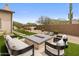 Outdoor living space with a modern fire pit, lounge seating, artificial turf, and desert landscaping at 20055 N 96Th Way, Scottsdale, AZ 85255