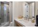 Bathroom with glass enclosed shower, undermount sink with marble countertops and square mirror at 20055 N 96Th Way, Scottsdale, AZ 85255