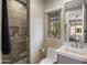 Bathroom showcasing a glass-enclosed shower, decorative window, and stylish fixtures and finishes at 20055 N 96Th Way, Scottsdale, AZ 85255