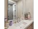 Bathroom with undermount sink, marble countertops, silver hardware, and a shower view at 20055 N 96Th Way, Scottsdale, AZ 85255