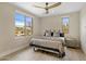 Bright bedroom featuring a ceiling fan, natural light, and views of the outdoor lounge area at 20055 N 96Th Way, Scottsdale, AZ 85255