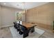 Elegant dining room with stylish light fixture, modern wall decor, and sleek wooden table with black chairs at 20055 N 96Th Way, Scottsdale, AZ 85255