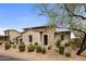 Inviting home with a stone and stucco exterior, lush desert landscaping, and a charming entryway at 20055 N 96Th Way, Scottsdale, AZ 85255