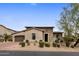 Charming single-story home featuring a stone facade, desert landscaping, and a welcoming entrance at 20055 N 96Th Way, Scottsdale, AZ 85255