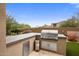 Outdoor grill area, perfect for entertaining, features built-in grill, stainless steel drawers, and ample counter space at 20055 N 96Th Way, Scottsdale, AZ 85255