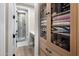 Hallway with a view of the bathroom, a shower with glass doors, and built-in shelving at 20055 N 96Th Way, Scottsdale, AZ 85255
