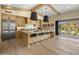 Bright kitchen features wooden cabinets, a large island with seating, and a seamless indoor/outdoor flow at 20055 N 96Th Way, Scottsdale, AZ 85255